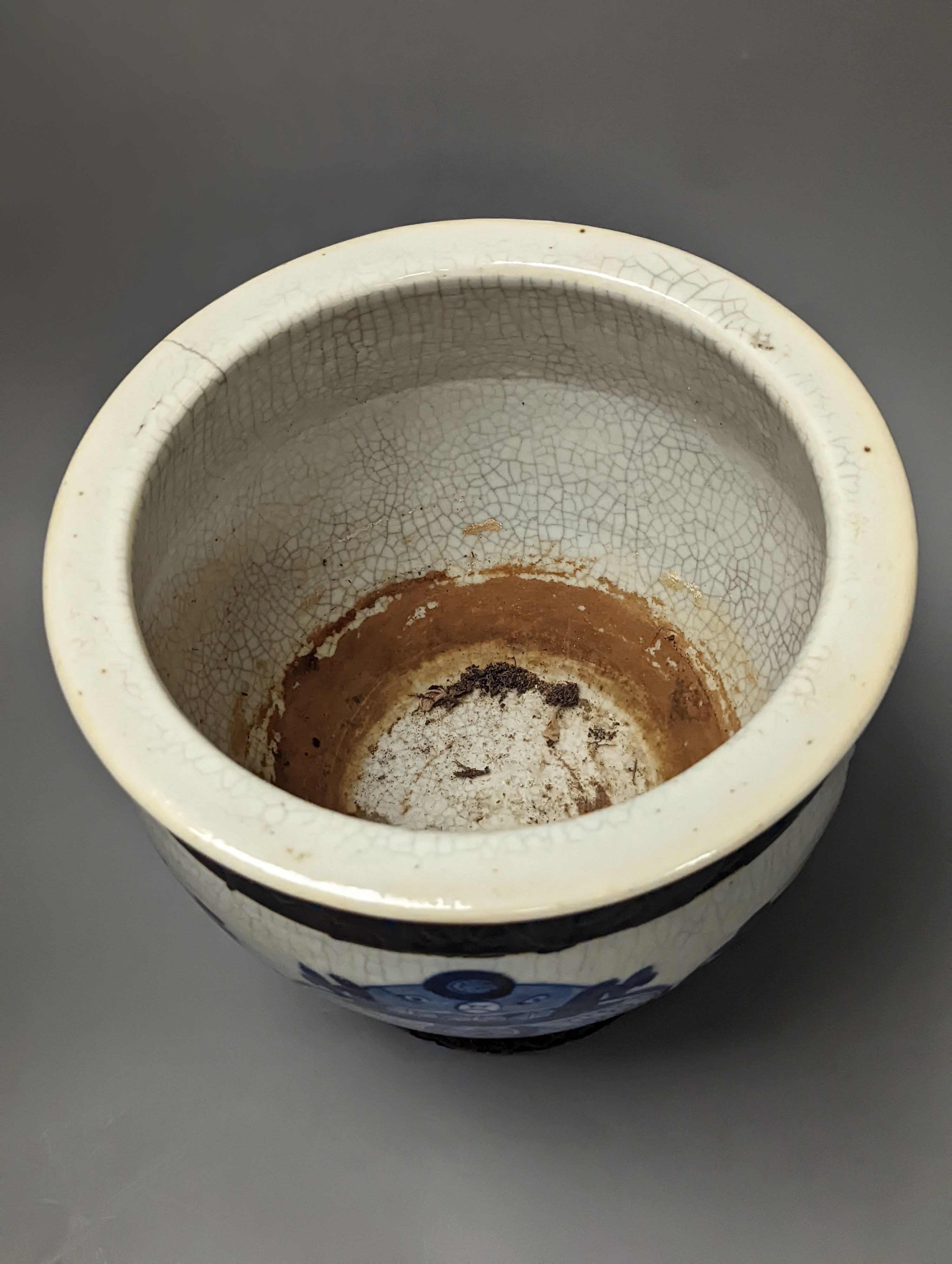 A Chinese blue and white crackle glazed jardiniere, early 20th century, wood stand. Total height 27cm